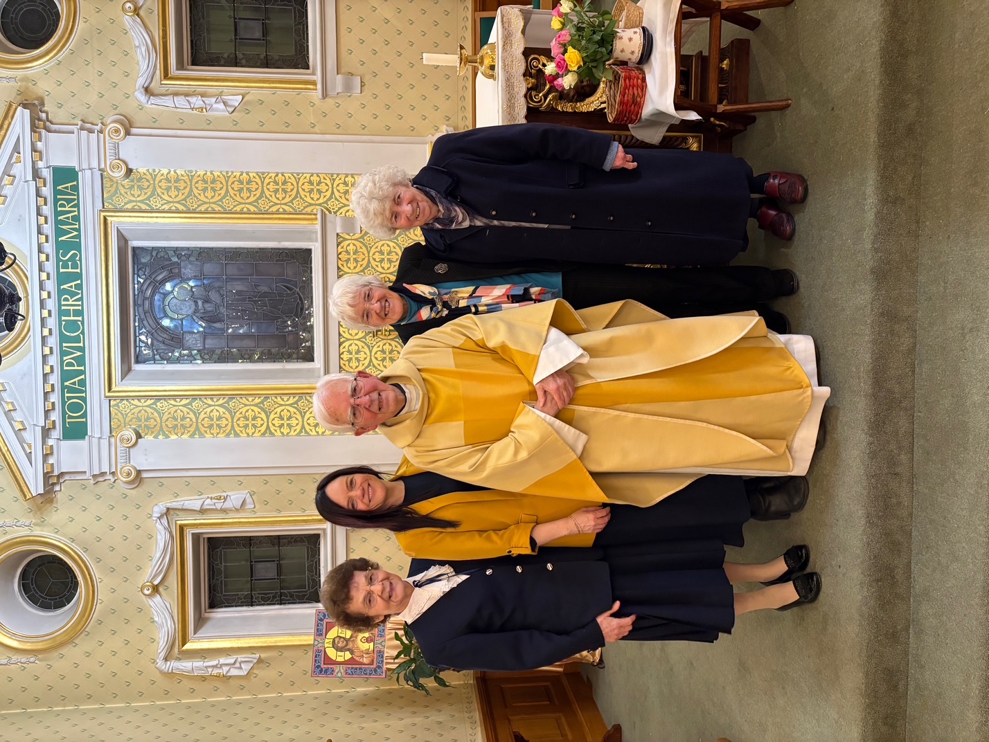 Mgr Daniel McHugh with Professor Alan McClelland's wife Marie and daughter Alkelda.